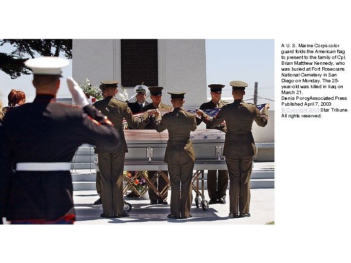 A U. S. Marine Corps color guard folds the American flag to present to