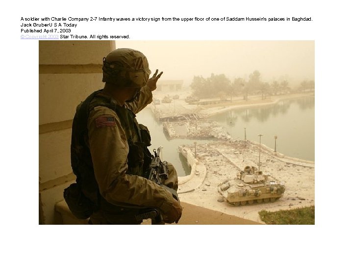 A soldier with Charlie Company 2 -7 Infantry waves a victory sign from the