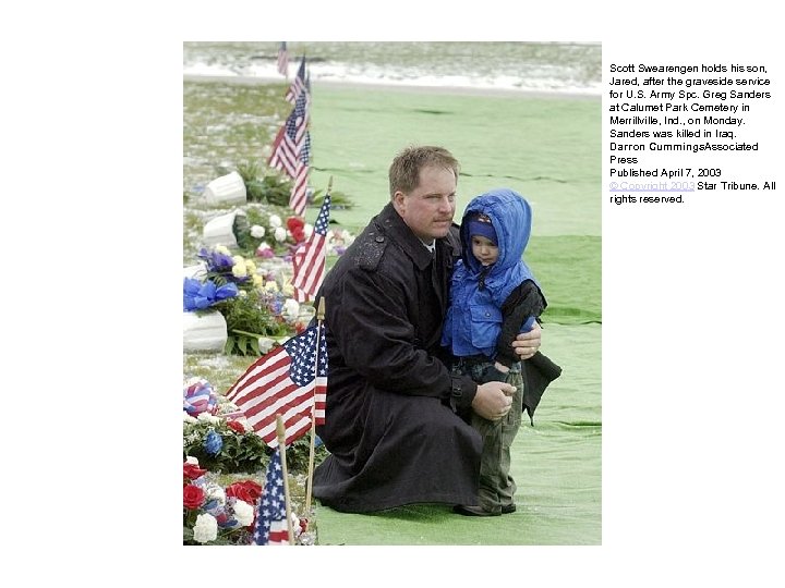 Scott Swearengen holds his son, Jared, after the graveside service for U. S. Army