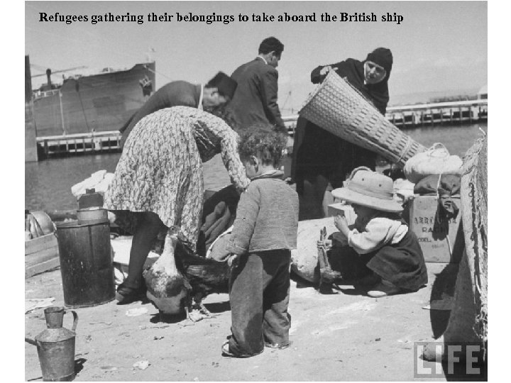 Refugees gathering their belongings to take aboard the British ship 