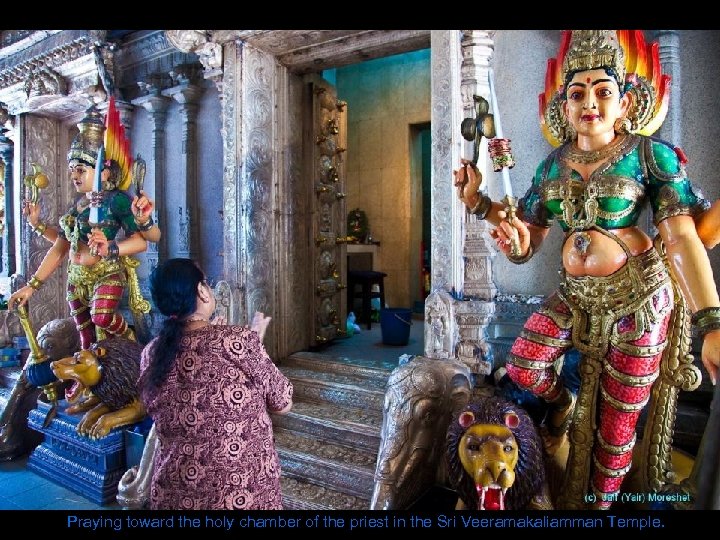 Praying toward the holy chamber of the priest in the Sri Veeramakaliamman Temple. 