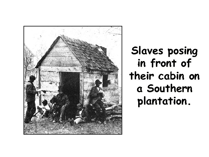 Slaves posing in front of their cabin on a Southern plantation. 