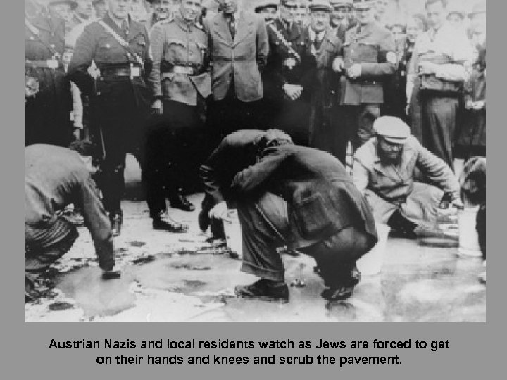 Austrian Nazis and local residents watch as Jews are forced to get on their