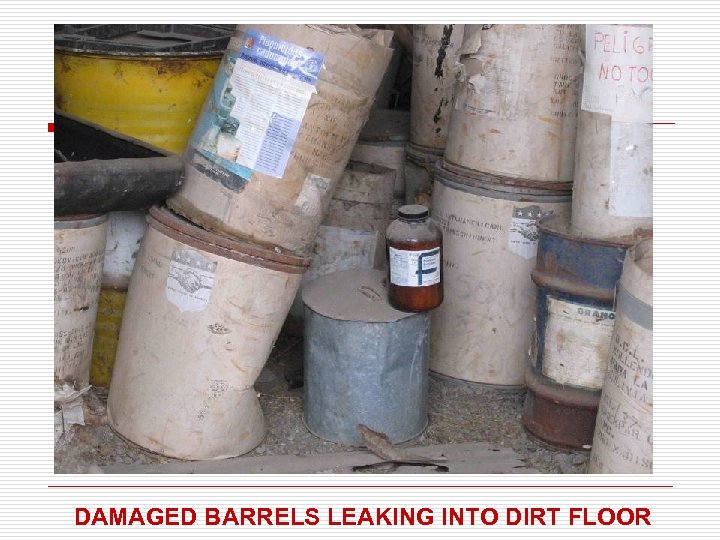 DAMAGED BARRELS LEAKING INTO DIRT FLOOR 