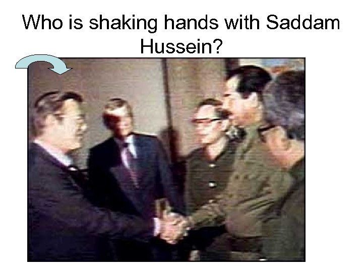 Who is shaking hands with Saddam Hussein? 