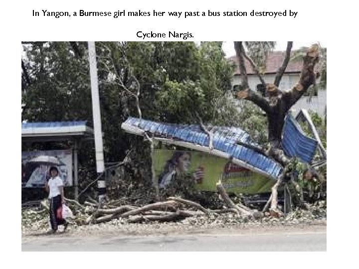 In Yangon, a Burmese girl makes her way past a bus station destroyed by