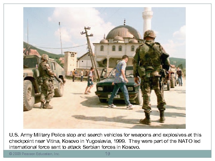 U. S. Army Military Police stop and search vehicles for weapons and explosives at