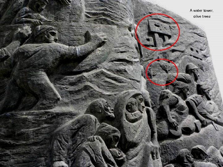 A water tower, olive trees 