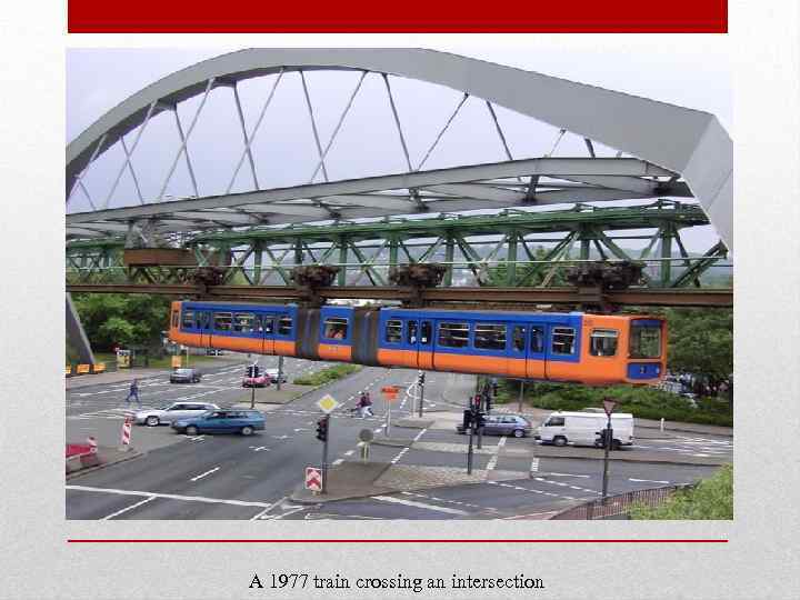 A 1977 train crossing an intersection 