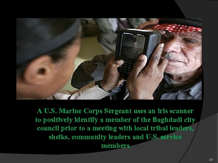 A U. S. Marine Corps Sergeant uses an iris scanner to positively identify a