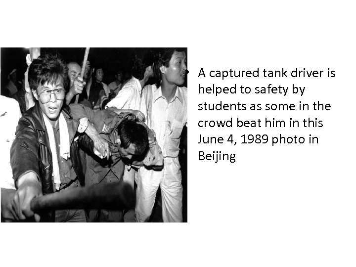  • A captured tank driver is helped to safety by students as some