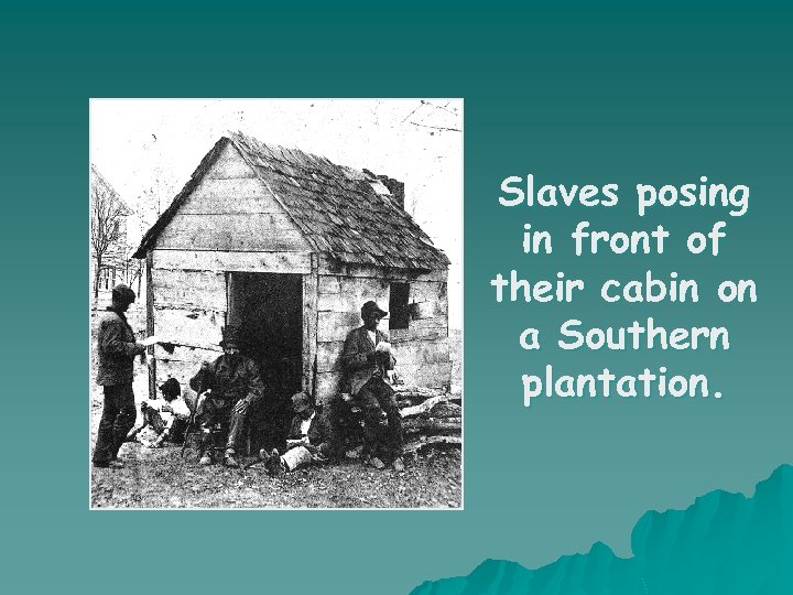 Slaves posing in front of their cabin on a Southern plantation. 