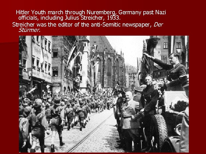  Hitler Youth march through Nuremberg, Germany past Nazi officials, including Julius Streicher, 1933.