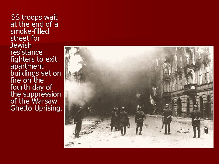  SS troops wait at the end of a smoke-filled street for Jewish resistance