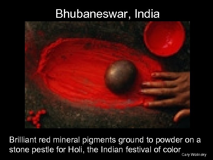 Bhubaneswar, India Brilliant red mineral pigments ground to powder on a stone pestle for