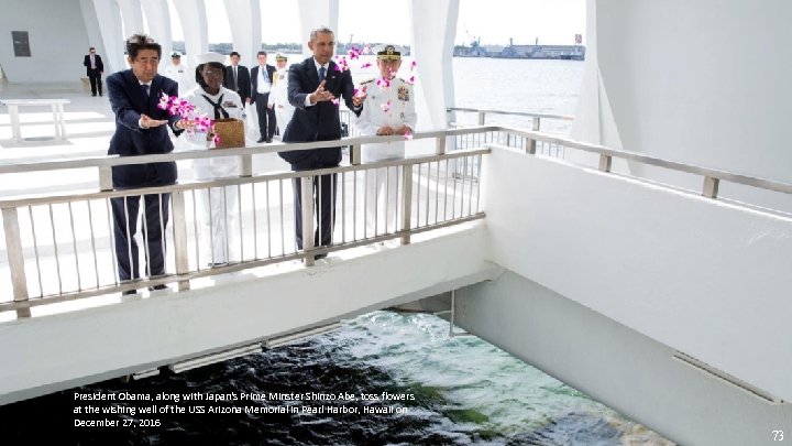President Obama, along with Japan's Prime Minster Shinzo Abe, toss flowers at the wishing