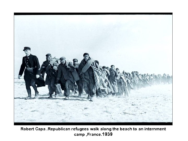 Robert Capa. Republican refugees walk along the beach to an internment camp , France.