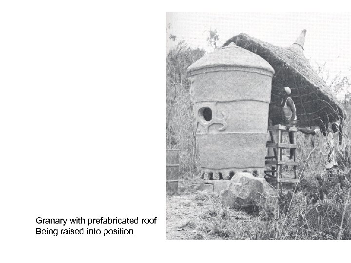 Granary with prefabricated roof Being raised into position 