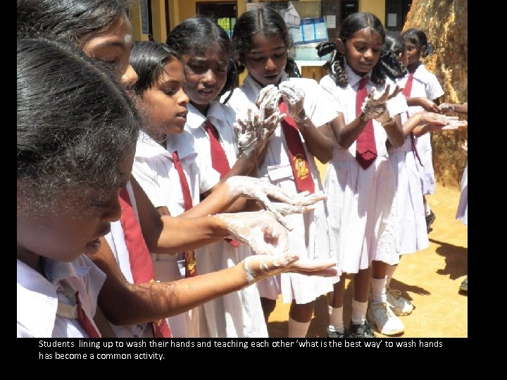 Students lining up to wash their hands and teaching each other ‘what is the