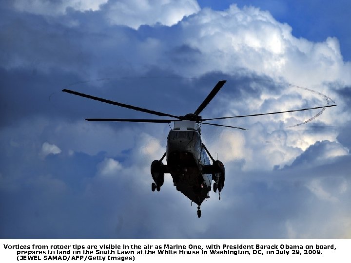 Vortices from rotoer tips are visible in the air as Marine One, with President