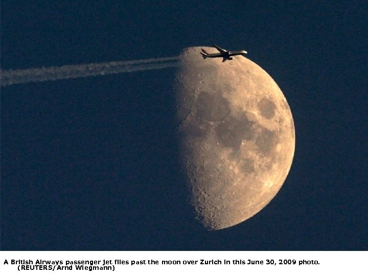 A British Airways passenger jet flies past the moon over Zurich in this June