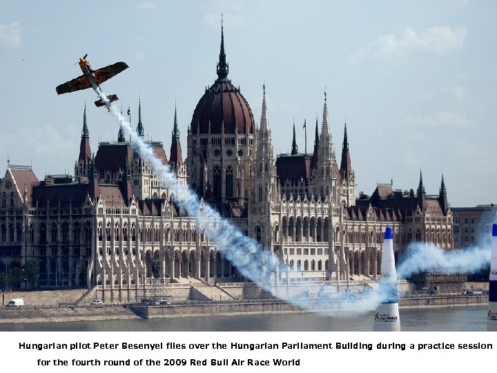 Hungarian pilot Peter Besenyei flies over the Hungarian Parliament Building during a practice session