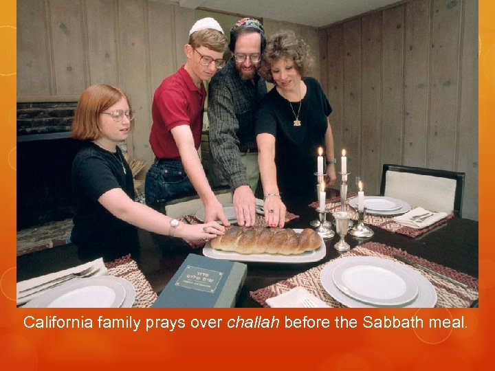 California family prays over challah before the Sabbath meal. 