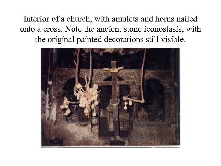 Interior of a church, with amulets and horns nailed onto a cross. Note the