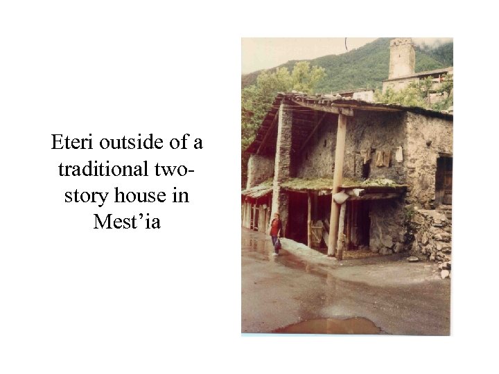 Eteri outside of a traditional twostory house in Mest’ia 