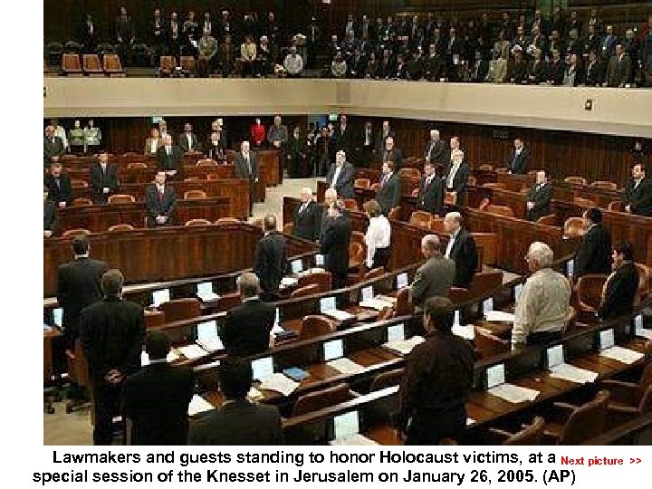 Lawmakers and guests standing to honor Holocaust victims, at a Next picture >> special