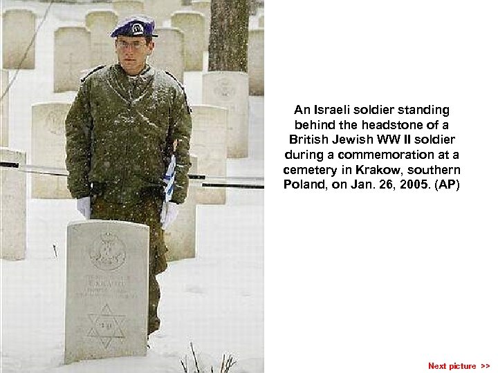 An Israeli soldier standing behind the headstone of a British Jewish WW II soldier