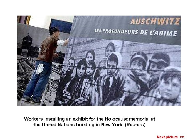 Workers installing an exhibit for the Holocaust memorial at the United Nations building in