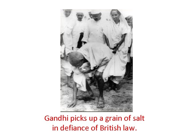 Gandhi picks up a grain of salt in defiance of British law. 