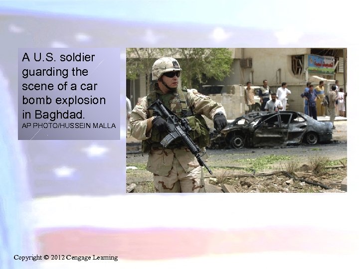 A U. S. soldier guarding the scene of a car bomb explosion in Baghdad.